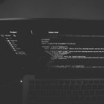 black and gray laptop displaying codes