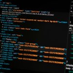 turned on monitor displaying programming language
