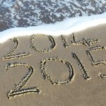 beach shore etch with 2014 and 2015 texts during daytime